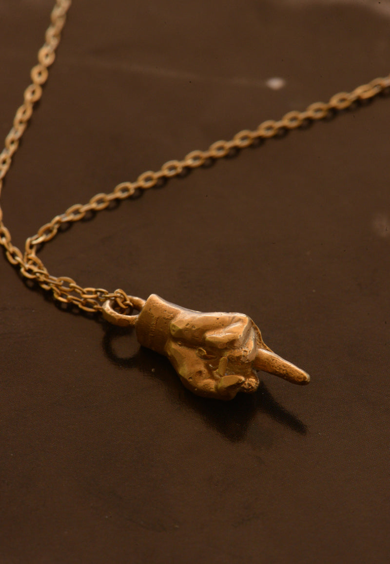 Hand-cast middle finger pendant in gold