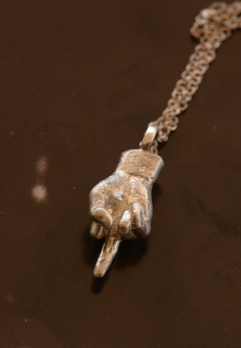Hand-cast middle finger pendant in silver